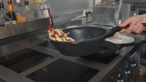 Chef Tossing Sautéed Vegetables in Commercial Kitchen