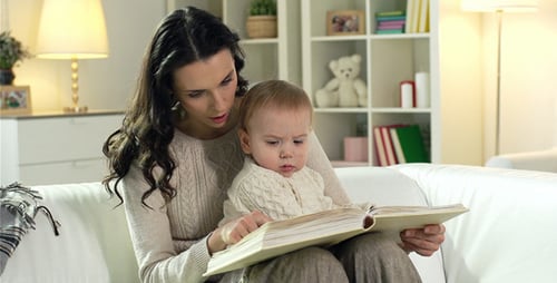 Woman and Infant Reading a Book Together