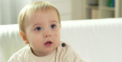 Cute Infant with Pumpkin Indoors at Home