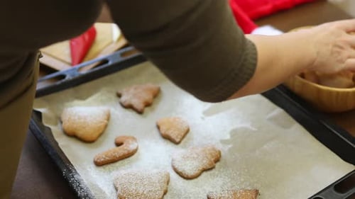 Decorating Christmas Cookies on Baking Sheet at Home