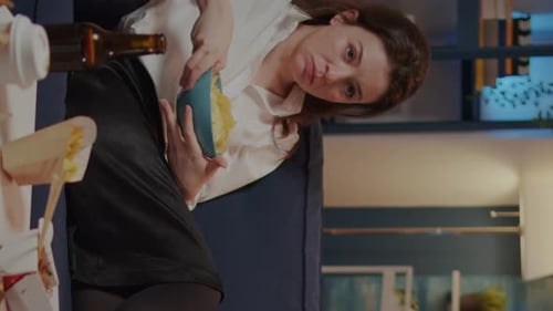 Vertical Video Caucasian Adult Relaxing on Couch with Chips As Snack