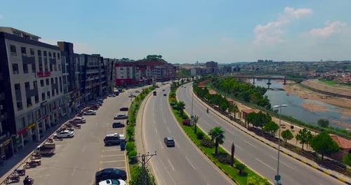 Model road with buildings and river drone view, bridge on the river, cars running on the road, Chitw