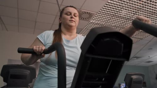 From down of overweight woman doing training at the gym. Shot with RED helium camera in 4K.