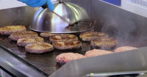 Cooking Burger Patties on a Sizzling Grill