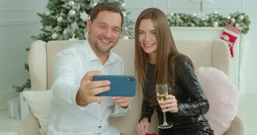 Couple Taking Christmas Selfies at Home Together