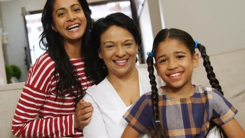 Multi-generation family sitting together in living room 4k