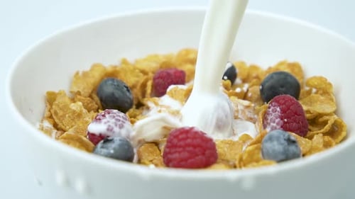 Milk Poured Over Cereal with Fresh Berries