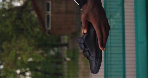 Handing Over a Stylish Black Shoe