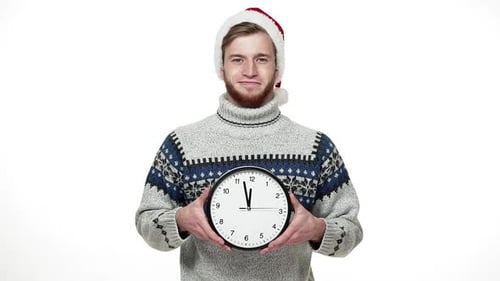 Slow Motion Handsome Man in Sweater Holding Clock Showing Time To Camera.