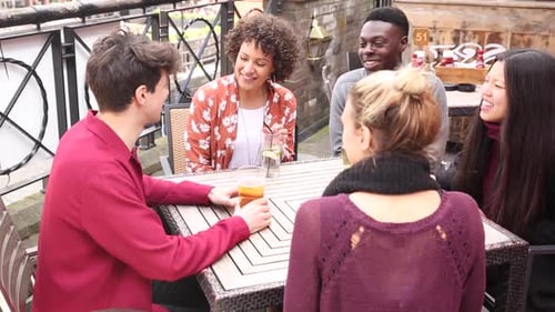 Friends Laughing Together at an Urban Restaurant