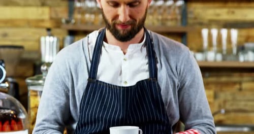 Bearded Man Holding Cup of Coffee in Cafe