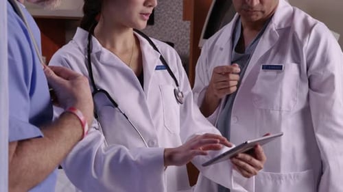 Medical Team Collaborating Using Tablet and X-Ray