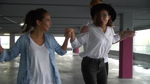 Friends Learning to Skateboard in Urban Parking Garage