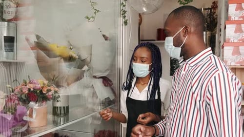 Florist and Male Customer Choosing Flower Bouquet at Store