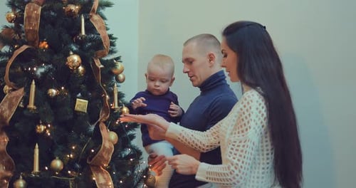 Happy Family Decorating Christmas Tree Together