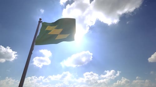 Green Flag with Yellow Geometric Shapes Waving in Bright Sky