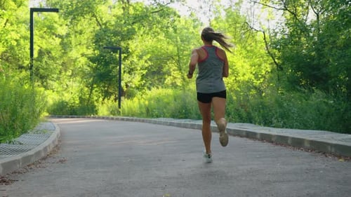 Blonde Woman Jogging on Road
