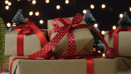 Festive Christmas Gifts with Red Ribbons and Lights