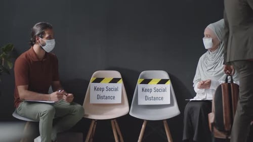 Man and Woman Waiting for Interview