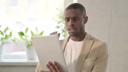 Portrait of African Man Having Loss on Tablet in Office
