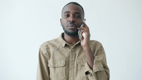 Man Talking on Phone, Smiling at Good News
