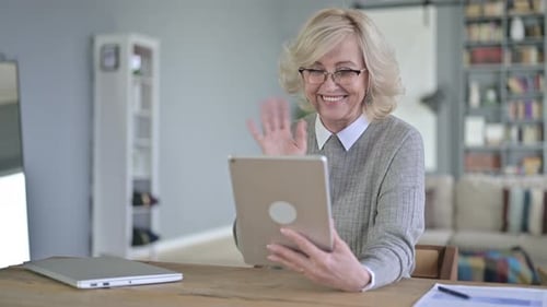 Woman Smiling and Waving During Video Call