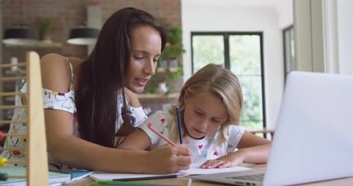 Woman and Girl Studying Together at Home
