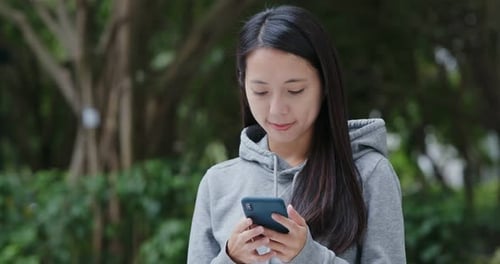 Woman Use of Mobile Phone in The Park