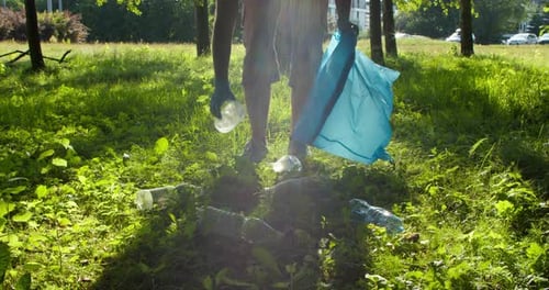Male Volunteer Cleans Plastic Garbage in the Park