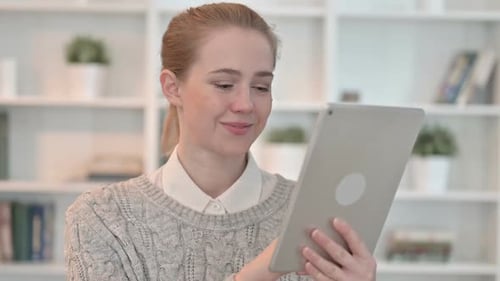 Young Woman Using Tablet Device Indoors