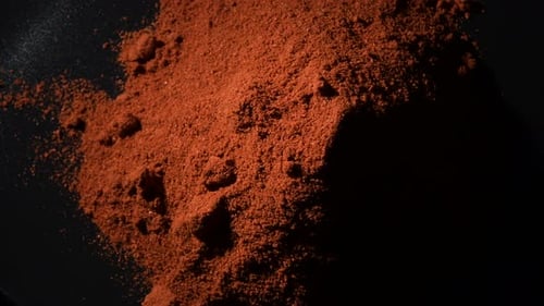 Reddish-Brown Spice Powder Close Up on Dark Surface