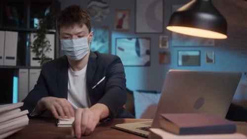 Student Working Late at Desk with Laptop