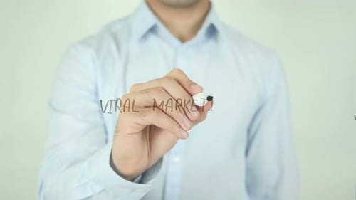 Man Writes Viral Marketing on Clear Surface