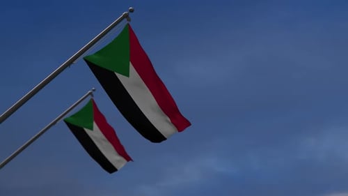 Realistic Waving Flags of Sudan against Blue Sky