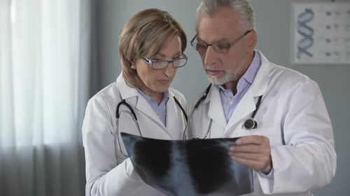 Doctors Reviewing Chest X-Ray in Medical Office