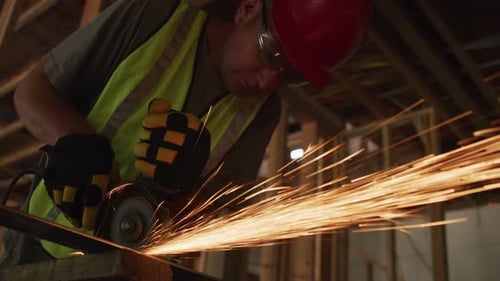 Construction Worker Cutting Metal with Power Tool