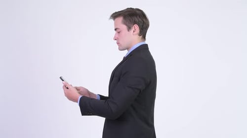 Profile View of Young Handsome Businessman Getting Phone Taken