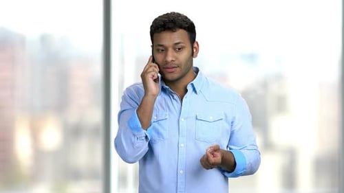 Excited Young Adult Man Talking on Phone