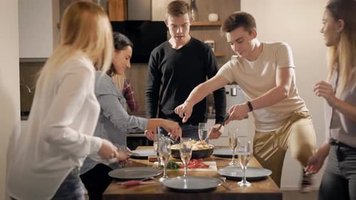 Young Adults Prepare and Serve Food Together