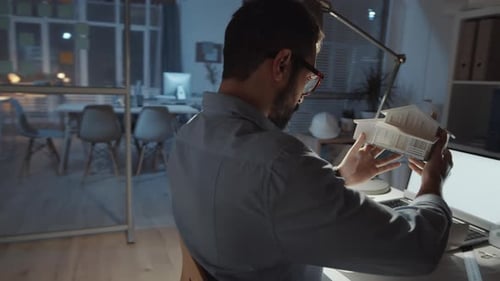 Middle Eastern Architect Examining House Model at Office Desk