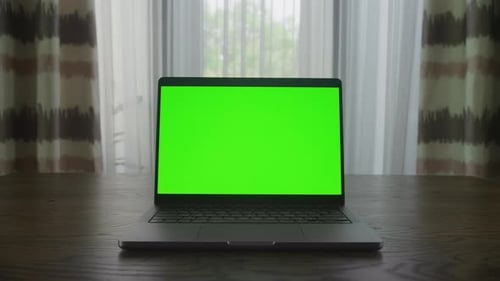 Slow Optical Zoom in Into a Laptop Computer with Green Screen Chroma Key Indoors