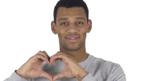 Man Makes Heart Shape with Hands