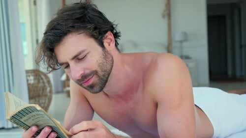 Man Reading Book Lying on Spa Bed