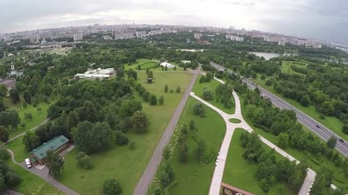 Flying Over the City with Vast Green Plantations