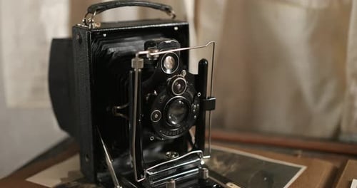 Vintage Camera on Display with Old Black Photos