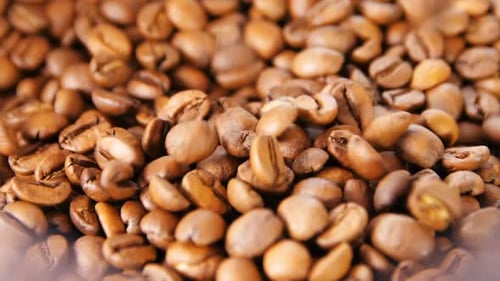 Close up of falling roasted coffee beans