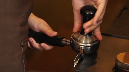 Barista Tamping Espresso Grounds Close Up