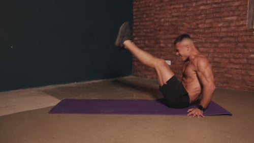 Fit Man Working Abs with Leg Raises
