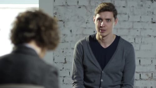 Man Talking to Therapist in Office Setting