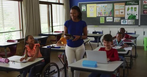 Teacher With Children in Classroom at School
